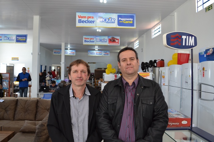 O diretor de Expansão do grupo Becker, Clemir José Schafer, e Pelufa durante a inauguração da unidade